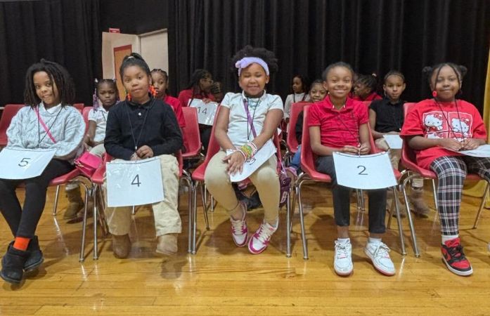  Students wait their turn to spell words for the spelling bee